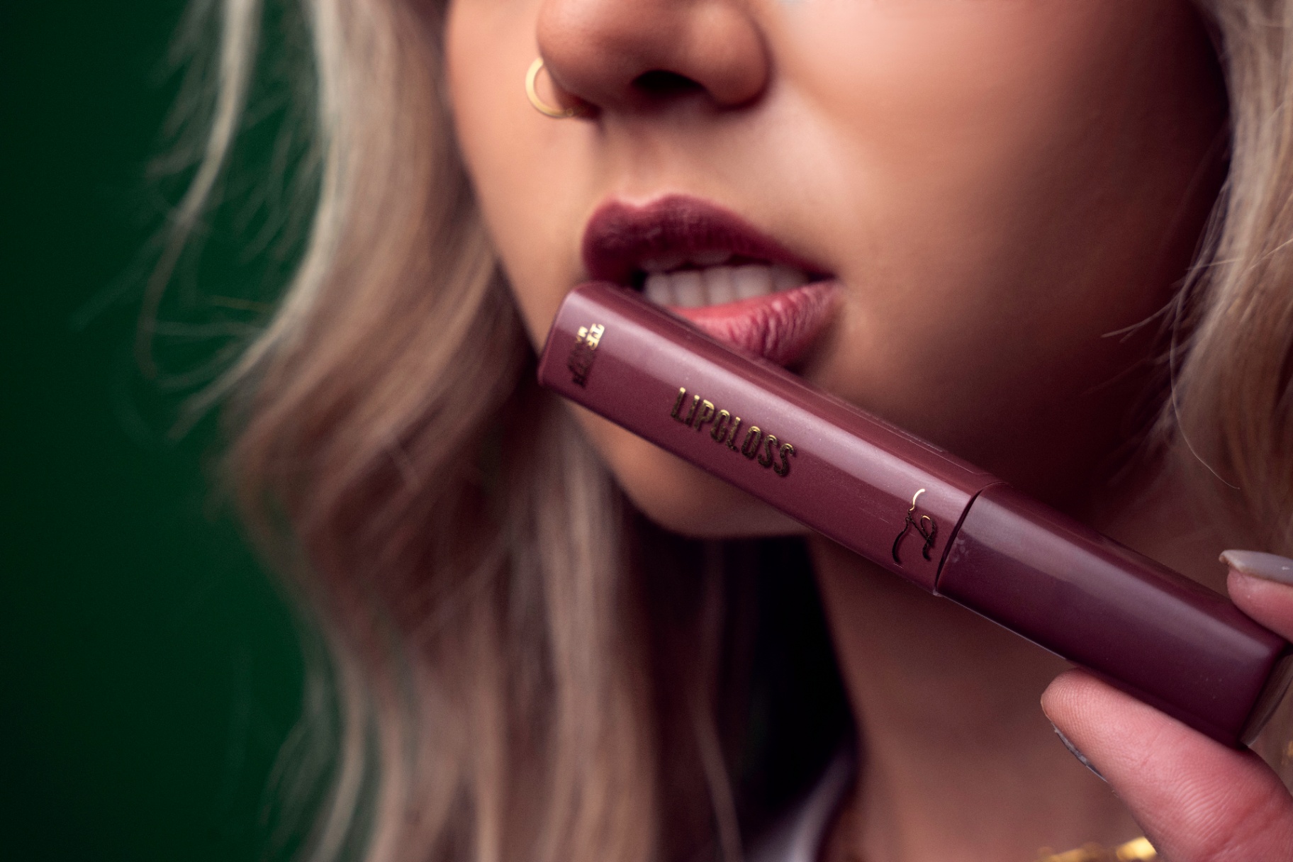 Close-up lip gloss shot on green